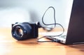 Camera connected to laptop with usb cable. File transfer to computer from DSLR. Back up storage for photos. Royalty Free Stock Photo