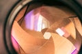 Camera diaphragm aperture with golden flare and reflection on lens Royalty Free Stock Photo