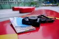 Travel essentials concept; camera, face mask, and a map on a bench Royalty Free Stock Photo