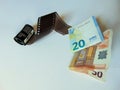 Camera film turning into money | stockphotography concept Royalty Free Stock Photo