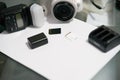 Camera ,flash,charger,battery and memory cards on table with white paper with copy space Royalty Free Stock Photo