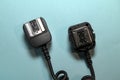 Camera flash sync cable on blue background Royalty Free Stock Photo