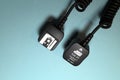 Camera flash sync cable on blue background Royalty Free Stock Photo
