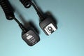 Camera flash sync cable on blue background Royalty Free Stock Photo