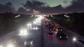 The camera flies over heavy traffic. Cars with lights on go through the city at night. 3D Rendering