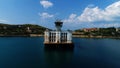 Camera flying towards the long pier with an old building with three towers. Shot. Aerial view of a blue sea coast with a Royalty Free Stock Photo