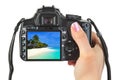 Camera in hand and beach landscape Royalty Free Stock Photo