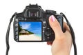 Camera in hand and beach landscape Royalty Free Stock Photo