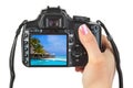 Camera in hand and beach landscape Royalty Free Stock Photo