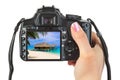 Camera in hand and beach landscape Royalty Free Stock Photo