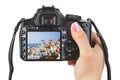 Camera in hand and Santorini (Greece) view Royalty Free Stock Photo