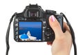 Camera in hand and Santorini (Greece) view Royalty Free Stock Photo