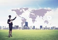 Camera headed woman standing on green grass against modern cityscape