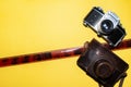 Camera, leather bag and tape for the picture. Yellow background and camera. Design for a photo studio