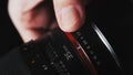 Close up of man\'s hand tuning a camera lens ring