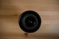 The camera lens on light wooden table Royalty Free Stock Photo