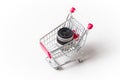 Camera lens in a shopping cart. Isolated on gray background. Royalty Free Stock Photo