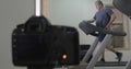 Camera making shots of man running on treadmill