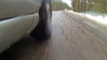 Camera mounted on a car when moving on winter road in forest. It goes sleet. Water splashes get on camera.