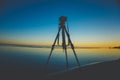 A Camera Mounted On A Tripod At The Beach, Capturing The Colorful Sunset From A Low Angle Perspective. Royalty Free Stock Photo