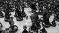 camera moves over different black chess pieces and focuses on the white king