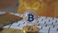 Camera moving around silver bitcoin cymbol on keyboard. Selective focus.