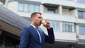 Camera moving around young handsome male standing outdoors drinking coffee. Close up portrait of Caucasian successful Royalty Free Stock Photo