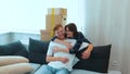 Camera moving back from young joyful couple of new owners of the apartment. Slow motion. Happy excited family bought new Royalty Free Stock Photo