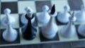 Camera moving from out of focus position into the chess battlefield where black queen standing among white figures. spy traitor