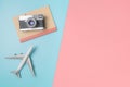 Camera and notebook for travel concept on blue pink background Royalty Free Stock Photo