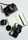 Old analogue camera and notepad. A clean notebook with a fountain pen and a retro camera on the table. Royalty Free Stock Photo