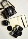 Old analogue camera and notepad. A clean notebook with a fountain pen and a retro camera on the table. Royalty Free Stock Photo