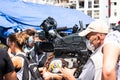 Camera operator with protective mask filming an event Royalty Free Stock Photo