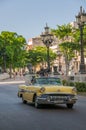 Classic yellow convertible classic car on the avenue of El Prado in Havana.Cuba