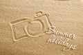 The camera is painted on the sand and the inscription is summer holidays. Beach background. View from above. The concept of summer Royalty Free Stock Photo