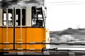 Camera panning- yellow tram in motion on the Danube Promenade, Budapest Royalty Free Stock Photo