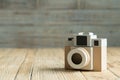 Camera paper on the wood background