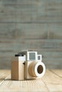 Camera paper on the wood background