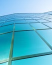 Facade of modern office building in glass and steel with reflections of blue sky Royalty Free Stock Photo