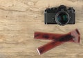 Camera and photographic 35 mm film strip on wood Royalty Free Stock Photo