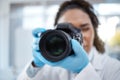 Camera, photography and lens with black woman in forensics laboratory for investigation, crime scene and evidence