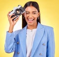 Camera, photography and woman portrait with a smile and wink for picture in studio. Happy, female person and yellow