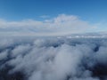 High above the thick fog, like beautiful ocean of clouds at sunrise. Sun is rising above the endless sea of clouds until Royalty Free Stock Photo