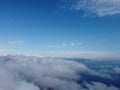 High above the thick fog, like beautiful ocean of clouds at sunrise. Sun is rising above the endless sea of clouds until Royalty Free Stock Photo