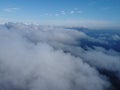 High above the thick fog, like beautiful ocean of clouds at sunrise. Sun is rising above the endless sea of clouds until Royalty Free Stock Photo