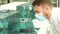 Lovely laboratory assistant looks closely at the work of the laboratory centrifuge Royalty Free Stock Photo