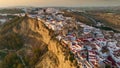 Camera rises over Arcos de la Frontera, Andalucia, Spain at sunset. Aerial shot one of famous pueblos blancos in