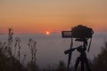 The camera shoots time laps of sunrise on a foggy morning