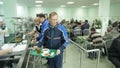 Camera shows workers take dinner and walk to tables