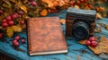 Camera sits on a table next to a notebook Royalty Free Stock Photo
